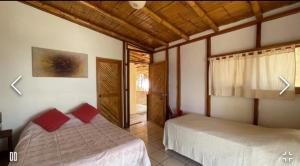 a bedroom with two beds in a room at Muelle Viejo Bungalows in Los Órganos
