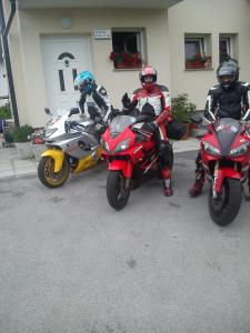 three people on motorcycles parked in front of a building at Apartment Damijan in Bled