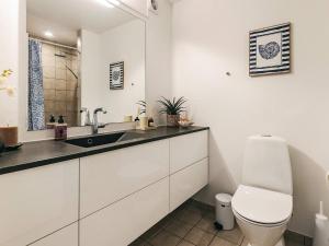 a white bathroom with a sink and a toilet at 5 star holiday home in Køge in Køge +24 photos