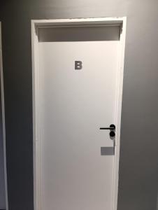 a white door with the letter b on it at Temporarios Moritan 1B in Posadas