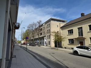 a white car parked on the side of a street at Seabreeze City Studio in Kristiansand