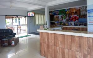 a kitchen with a wooden counter and a bar at Via Norte Hotel in Gurupi