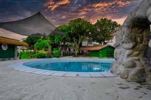 a swimming pool in the middle of a resort at THE OASIS RESORT CondoBimbo 1-Big Room, Balcony, kitchen, Pool, Wifi, Videoke in San Fernando