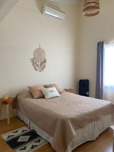 a bedroom with a bed and a chandelier at Buen Descanso 2 in San Pedro