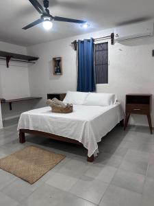 a bedroom with a bed and a ceiling fan at Casa Flamboyán in Santa Bárbara