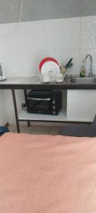 a kitchen counter with a sink and a microwave at Habitación privada in Iquique
