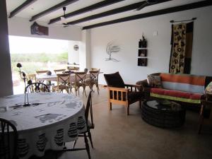 a living room with a table and chairs at Nathi Kruger View Guest House in Marloth Park