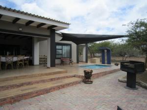 a house with a patio and a swimming pool at Nathi Kruger View Guest House in Marloth Park