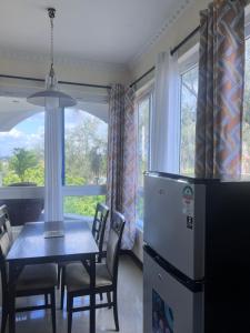 a dining room with a table and chairs and a refrigerator at Sunrise-Nyali, Mombasa in Nyali
