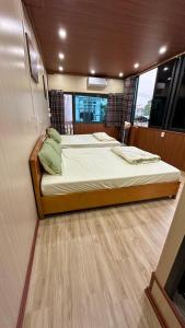 a bedroom with two beds on a boat at cat homestay in Hoàng Ngà