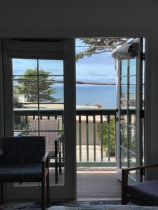 a room with a view of the ocean from a balcony at Carmel Beach Hotel in Carmel