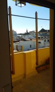 a view from the window of a yellow building at Apartamento Calle Goles in Seville