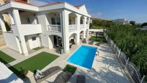 an aerial view of a house with a swimming pool at Apartments with swimming pool Pag - 24360 in Pag