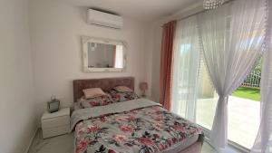 a bedroom with a bed and a large window at Apartments with swimming pool Pag - 24360 in Pag +18 photos
