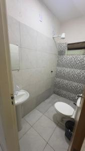 a bathroom with a sink and a toilet and a shower at Villas Hotel in Barreiras