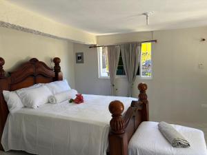 a bedroom with two beds with white sheets and flowers on them at Derbys Beach Escape in Hopewell