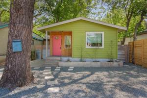 a green house with a red door and a tree at Authentic ATX Dtwn Beauty - Pool, Fenced Yard, Walk 2 Best Eateries & BBQ in Austin