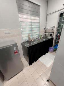 a kitchen with a sink and a large window at Lanuna Homestay Banting in Banting