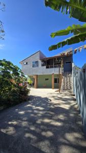 a large house with a driveway in front of it at Residencial Mineiro- apartamento de 02 quartos in Itapoa +12 photos