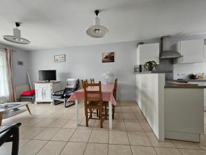 a kitchen and living room with a table and chairs at Maisonnette près du centre, proche plage et commerces - FR-1-476-84 in LʼAiguillon-sur-Mer