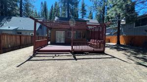 a small cabin with a porch in a yard at Bambi's Bunkhouse home in South Lake Tahoe