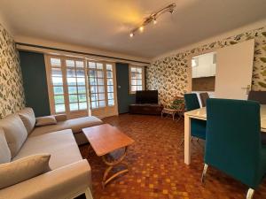 a living room with a couch and a table at Appartement avec jardin et piscine privée à Ciboure - FR-1-239-1121 in Ciboure