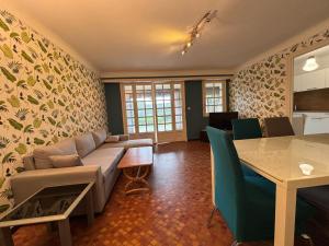 a living room with a couch and a table at Appartement avec jardin et piscine privée à Ciboure - FR-1-239-1121 in Ciboure