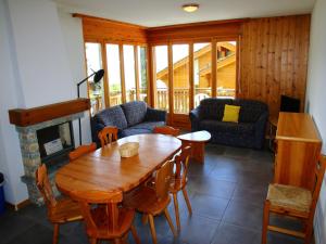 a living room with a wooden table and a fireplace at Alluring apartment in Les Agettes in Agettes