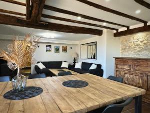 a living room with a wooden table and a couch at Villa With Pyrenees View Near Foix in Cassagne