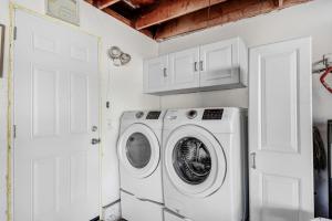 a washer and dryer in a white laundry room at Beautiful 2 bed 1 ba condo centrally located in OC in Placentia