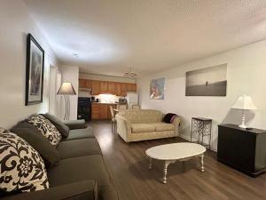a living room with a couch and a table at New Management - Collingwood Getaway in Collingwood