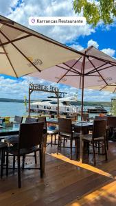 a restaurant with tables and chairs and an umbrella at Casa Lanôh in Canindé de São Francisco