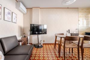 a living room with a couch and a table at okn飛騨高山202 in Takayama