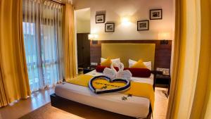 Postel nebo postele na pokoji v ubytování Hotel Kamrel Sigiriya