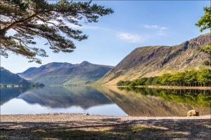 a view of a lake with mountains in the background at The Warehouse Apartments, 1 - Bed, Sleeps 2, Ulverston - UK in Ulverston