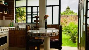 a kitchen with a table with a vase on it at Casa Flor de Vida in San Cristóbal de Las Casas