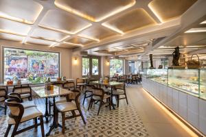 a restaurant with tables and chairs and a counter at La Moon Puducherry in Puducherry