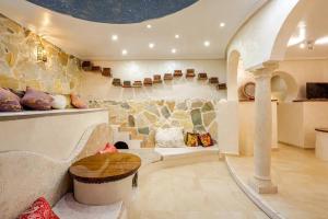 a living room with a table and a stone wall at Charming Studio in Torrevieja, 75 sqm with Shared Pool in Torrevieja