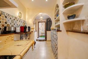 a kitchen with an archway and a counter top at Charming Studio in Torrevieja, 75 sqm with Shared Pool in Torrevieja +13 photos