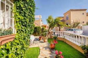 a garden with plants and flowers on a balcony at Charming Studio in Torrevieja, 75 sqm with Shared Pool in Torrevieja