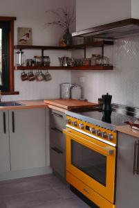 a kitchen with a yellow stove top oven at The Ridge Retreat on Litchfield in Rum Jungle Station