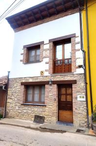 a house with two windows and a door at CASA ANGELITA INTRIAGO CANGAS DE ONis in Cangas de Onís