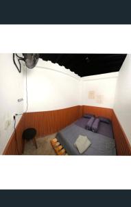 a bedroom with a bed in a room with a ceiling at Cilacap Guest House , Penginapan lokasi strategis di Depan terminal bus cilacap in Cilacap
