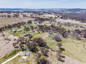 an aerial view of a field with trees at Captain Thunderbolt Bubbletent at Mirumiru in Tenterfield