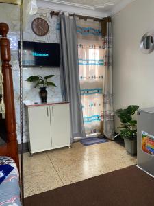 a room with a door with a plant in it at Kabale studio apartments in Kabale +11 photos