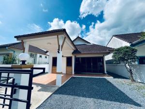 a house with a gate and a garage at B House in Ban Huai Khram