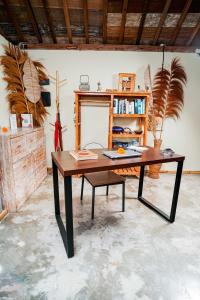 a wooden table with a bench in a room at Nila Chandra Bungalows in Ubud