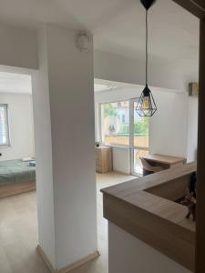 a kitchen and living room with white walls at Апартамент за гости ''ЗДРАВЕ'' in Kyustendil +4 photos