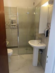 a bathroom with a shower and a sink and a toilet at 2 Bedrooms larnaca Finikoudes in Larnaka