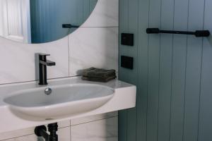 a bathroom with a white sink and a mirror at Parrys Estate at Parry Beach in Parryville +18 photos